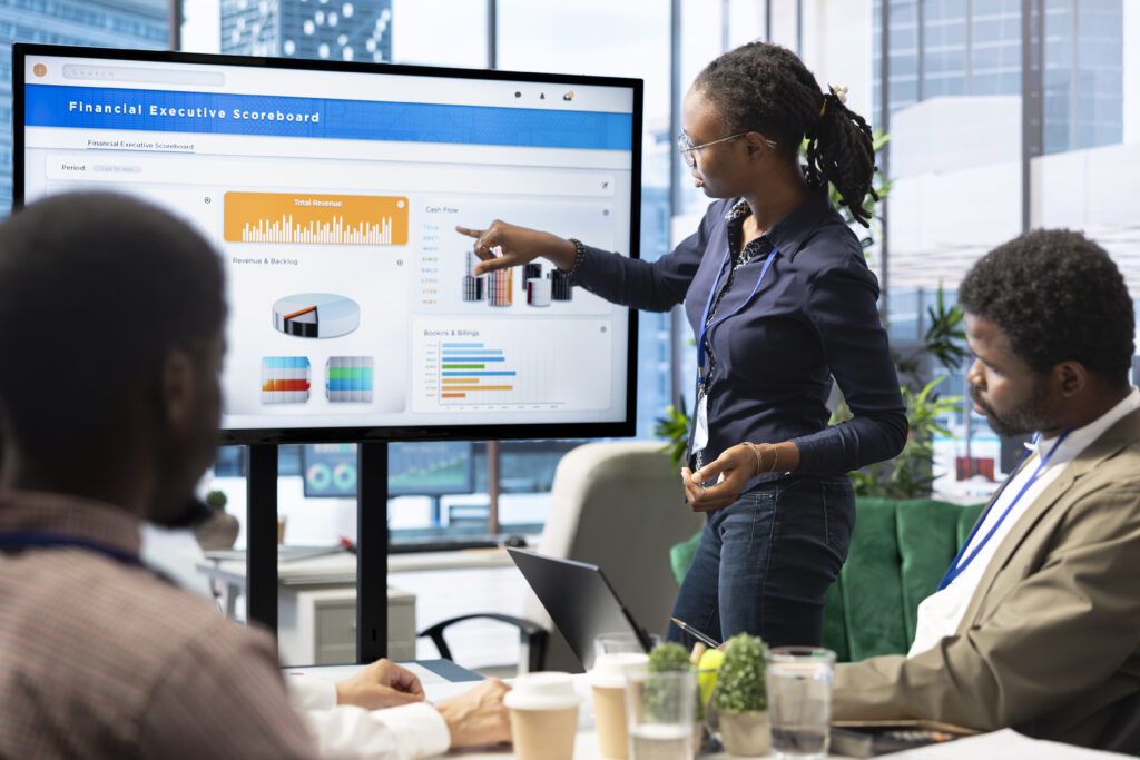 Advisory board members and team leaders gathering to review project outcomes, discuss resource allocation to ensure objectives achievement. Diverse business associates in a meeting.